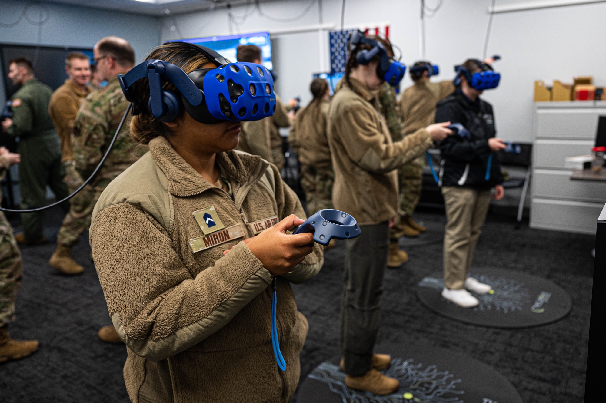 A woman in uniform wears a blue VR headset