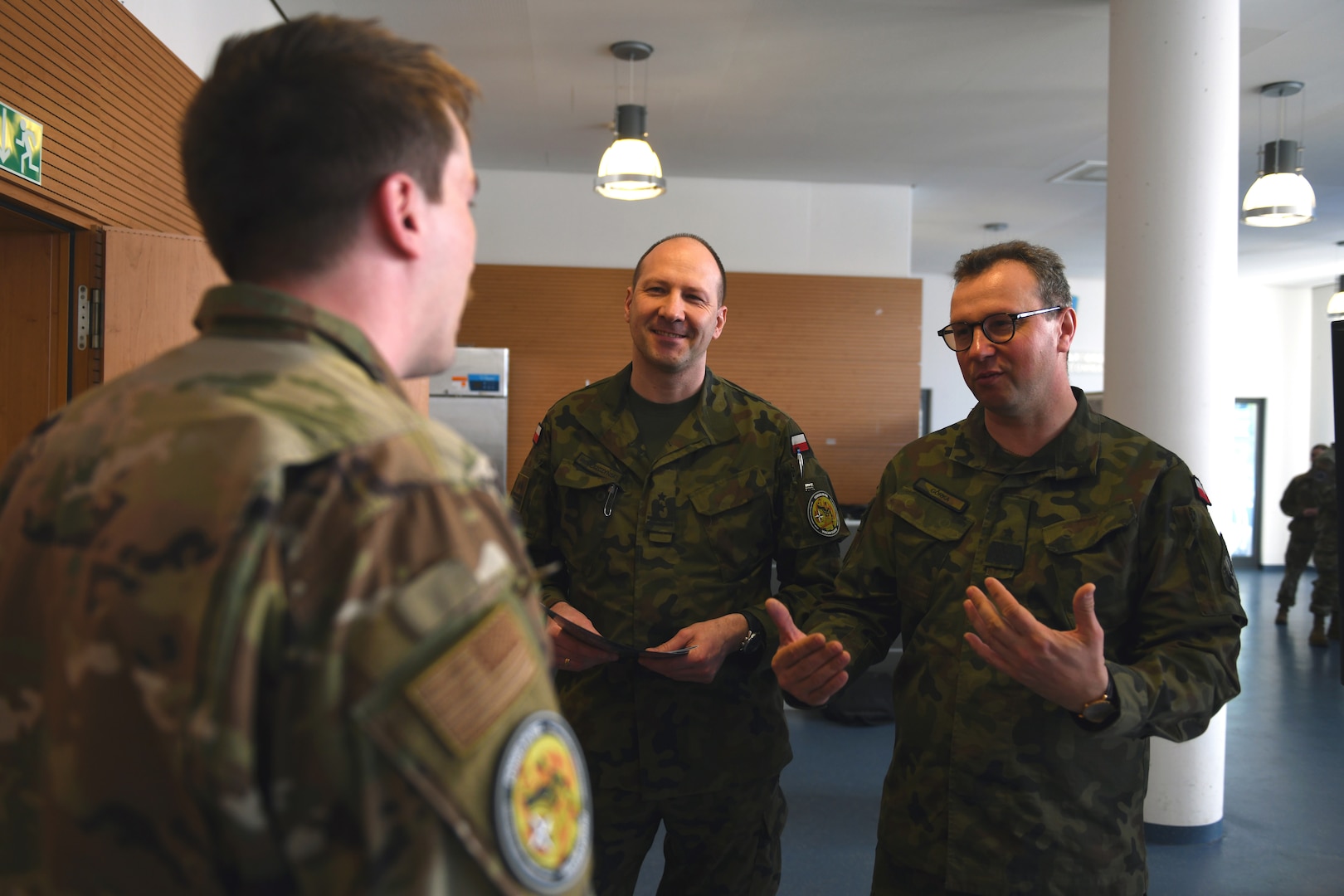 An Air National Guard member talks with Lt. Col. Maciej Wereszczynski, center, a senior specialist in the Space Technology Branch in Poland’s Ministry of National Defence, and Brig. Gen Marcin Gorka, director of the Department of Innovation of the Polish Ministry of National Defence and Plenipotentiary of the Minister of National Defence for Space, during Vulcan Guard Bolt 6, Ramstein Air Base, Germany, March 28, 2024. The space-focused exercise, now in its sixth iteration, is an Air National Guard-led event that seeks to integrate operations, intelligence and cyber personnel from across all seven Guard space states and NATO partners, incorporating several diverse space weapons systems in a realistic threat-based scenario.