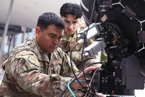 Air Force Staff Sgt. Javin Delgado, an electronic warfare specialist with the Hawaii Air National Guard’s 154th Wing, prepares to calibrate electronic warfare equipment as Senior Airman Oscar Mendoza, a space systems operator with the 148th Space Operations Squadron, looks on during Vulcan Guard Bolt 6, Ramstein Air Base, Germany, March 27, 2024. Though not part of the mission planning portion of the space-focused exercise, Delgado and Mendoza showcased EW assets to Vulcan Guard participants and distinguished visitors.