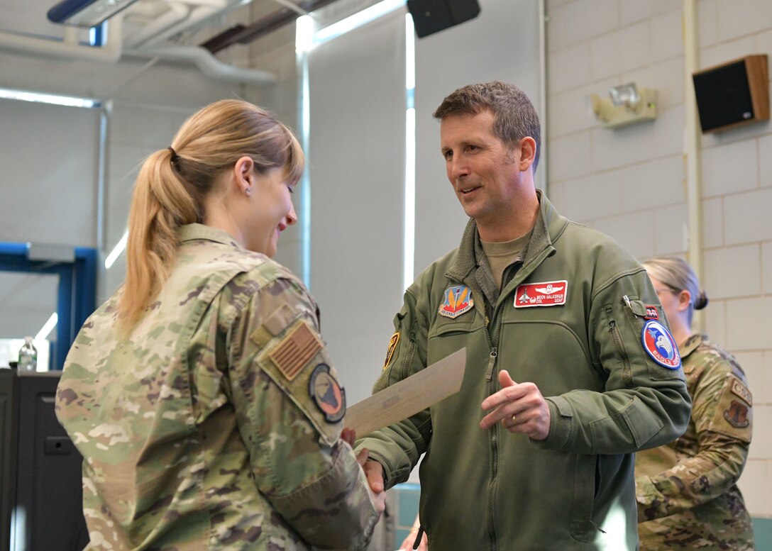 Colonel David Halasi-Kun, 104th Fighter Wing commander, presents superior performer award to master sergeant Jennifer Tittle, 104th Civil Engineering Squadron prime base engineer emergency force manager, Thursday, March 21, 2024, at Barnes Air National Guard Base, Massachusetts. The 104th FW received 29 individual and 9 team recognitions and awards from the 2024 unit effectiveness inspection for superior performance.