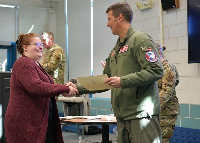 Colonel David Halasi-Kun, 104th Fighter Wing commander, presents superior performer award to Lisa Potitio, Barnes Wellness Team program manager, Thursday, March 21, 2024, at Barnes Air National Guard Base, Massachusetts. The 104th FW received 29 individual and 9 team  recognitions and awards from the 2024 unit effectiveness inspection for superior performance.