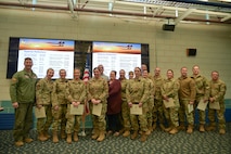 Colonel David Halasi-Kun, 104th Fighter Wing commander, poses for a photo with superior performer recipients, Thursday, March 21, 2024, at Barnes Air National Guard Base, Massachusetts. The 104th FW received 29 individual and 9 team  recognitions and awards from the 2024 unit effectiveness inspection for superior performance.