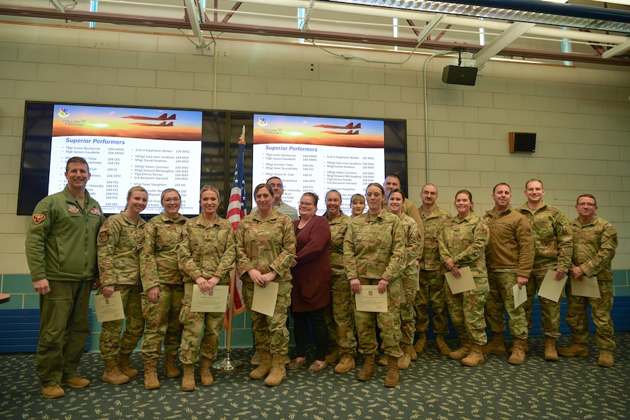 Colonel David Halasi-Kun, 104th Fighter Wing commander, poses for a photo with superior performer recipients, Thursday, March 21, 2024, at Barnes Air National Guard Base, Massachusetts. The 104th FW received 29 individual and 9 team  recognitions and awards from the 2024 unit effectiveness inspection for superior performance.