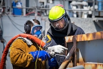 Surge Maintenance Hull Maintenance Technician Petty Officer 2nd Class Gerardo Vasquez, left, tries out for the first time.