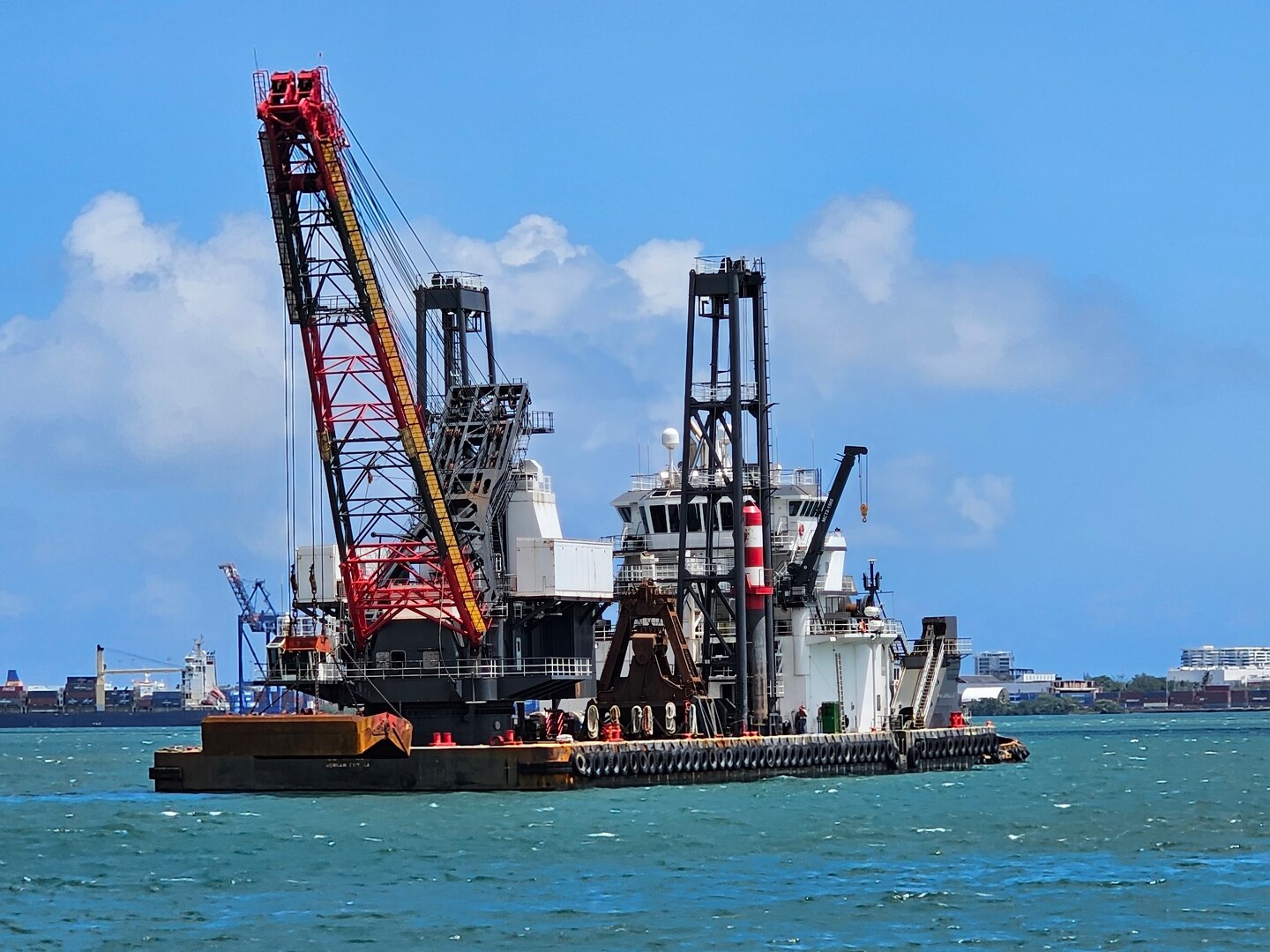 A dredging vessel on the blue green ocean.