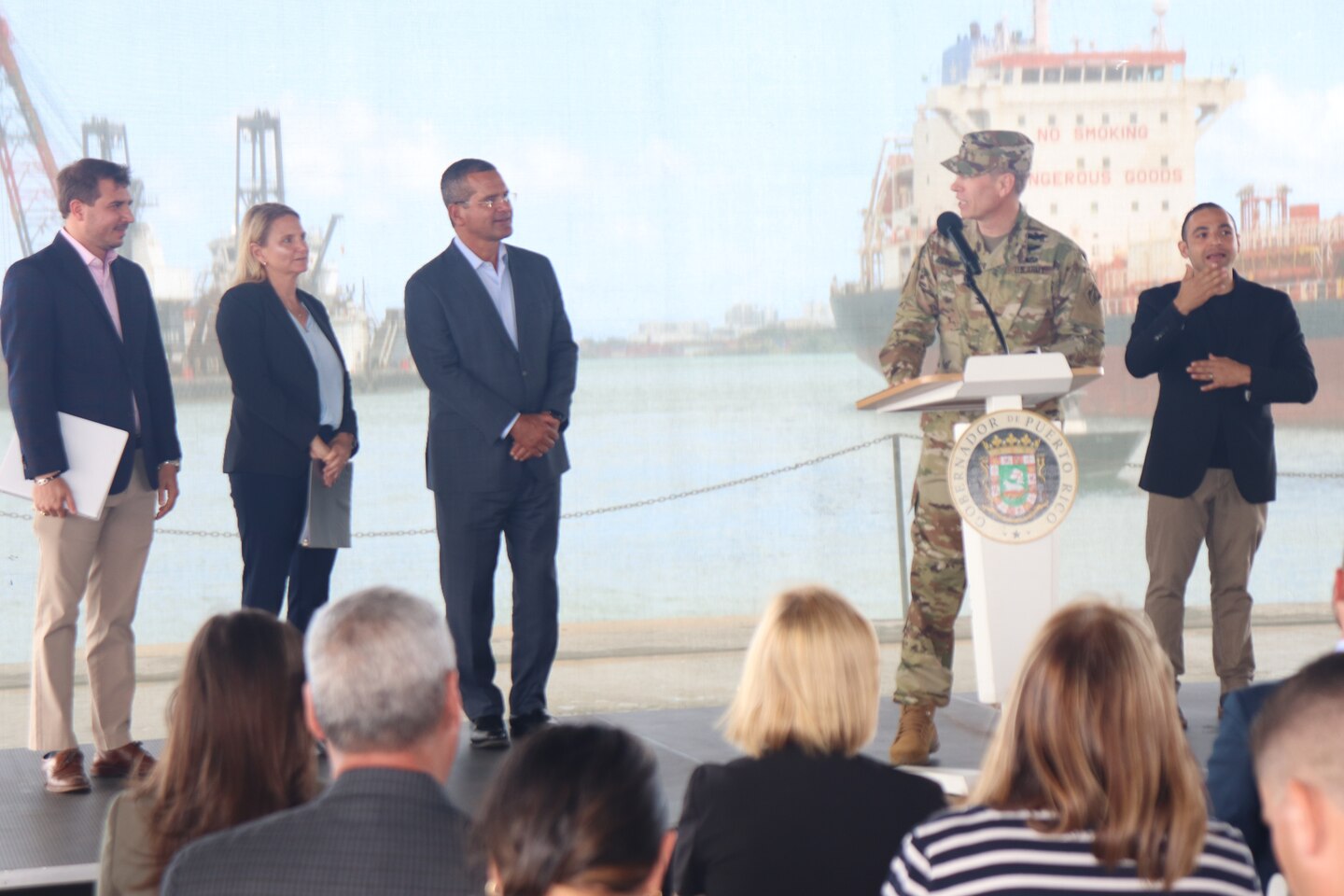 Col. Charles Decker in uniform at a podium