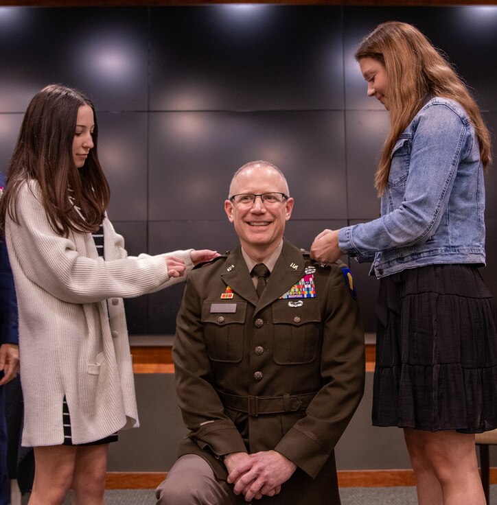 Rachel and Megan Eastridge, daughters of newly promoted U.S. Army Brig. Gen. Michael Eastridge, of Plymouth, Michigan, Deputy Assistant Adjutant General, Illinois Army National Guard, pins on general officer rank during a promotion ceremony April 6 at the Illinois Military Academy, Camp Lincoln, Springfield, Illinois.