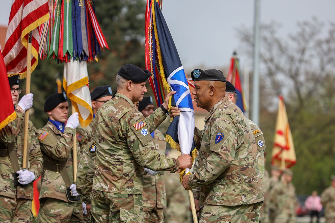 U.S. Army Lt. Gen. Charles Costanza, incoming V Corps commanding general, receives the corps guidon from Gen. Darryl Williams, commander of U.S. Army Europe and Africa, during a change of command ceremony at Camp Kościuszko in Poznan, Poland, April 8, 2024. Costanza, who previously served as the commanding general of 3rd Infantry Division, relieved Lt. Gen. John S. Kolasheski as V Corps commanding general during the ceremony. (U.S. Army photo by Spc. Devin Klecan)