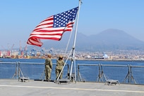 240407-N-JC445-1007 NAPLES, Italy (April 7, 2024) Electronics Technician 3rd Class Michael Thompson and Religious Program Specialist 1st Class Ashley Ferguson raise the Ensign during sea and anchor detail aboard the Blue Ridge-class command and control ship USS Mount Whitney (LCC 20) as it arrives in Naples, Italy. Mount Whitney, the U.S. Sixth Fleet flagship, is on a scheduled port visit to participate in the 75th anniversary of the NATO Alliance and enhance U.S.-Italian relations. Homeported in Gaeta, Mount Whitney operates with a combined crew of U.S. Sailors and Military Sealift Command civil service members. (U.S. Navy photo by Mass Communication Specialist 2nd Class Mario Coto)