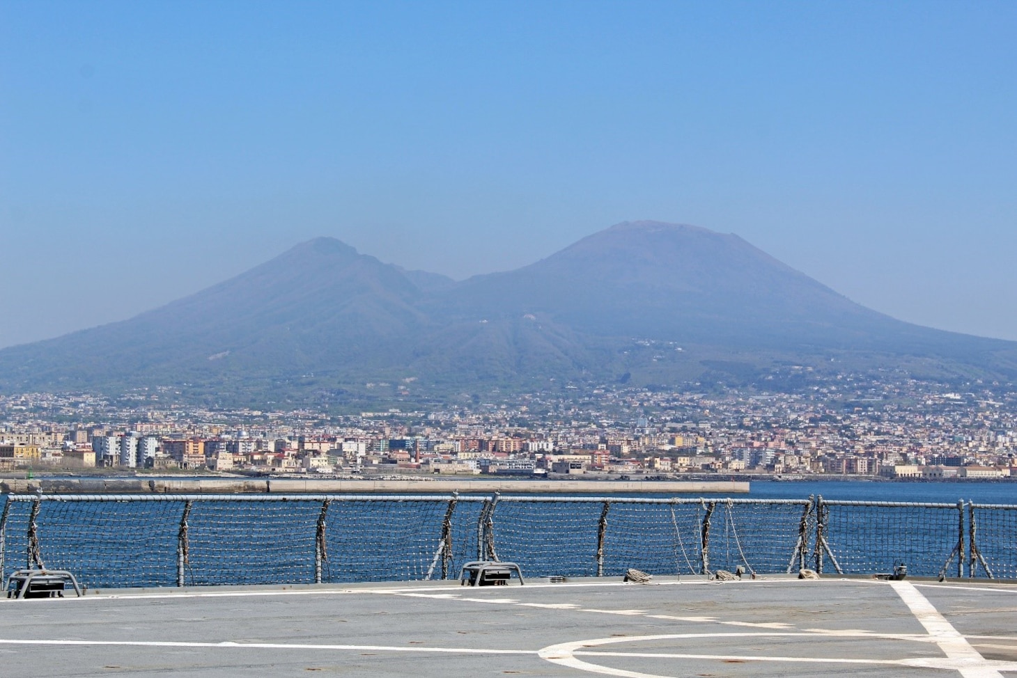 240407-N-JC445-1003 NAPLES, Italy (April 7, 2024) A photo of Mount Vesuvius as the Blue Ridge-class command and control ship USS Mount Whitney (LCC 20) arrives in Naples, Italy. Mount Whitney, the U.S. Sixth Fleet flagship, is on a scheduled port visit to participate in the 75th anniversary of the NATO Alliance and enhance U.S.-Italian relations. Homeported in Gaeta, Mount Whitney operates with a combined crew of U.S. Sailors and Military Sealift Command civil service members. (U.S. Navy photo by Mass Communication Specialist 2nd Class Mario Coto)