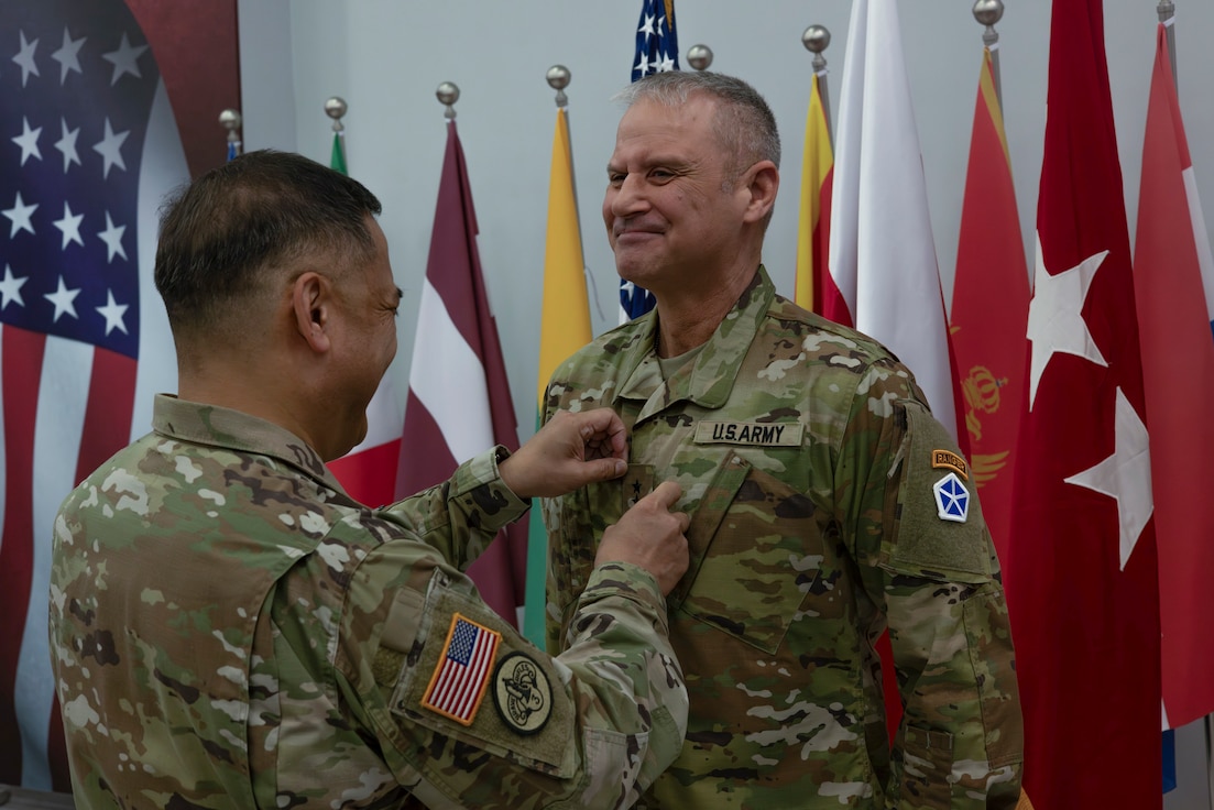 U.S. Army Lt. Gen. Antonio Aguto, the commanding general of Security Assistance Group-Ukraine, promotes Lt. Gen. Charles Costanza, the incoming commander of V Corps, in Poznan, Poland, April 8, 2024. Costanza followed Aguto as the commander of the 3rd Infantry Division, and will now work with him closely in Europe. (U.S. Army photo by Staff Sgt. Jameson Harris)