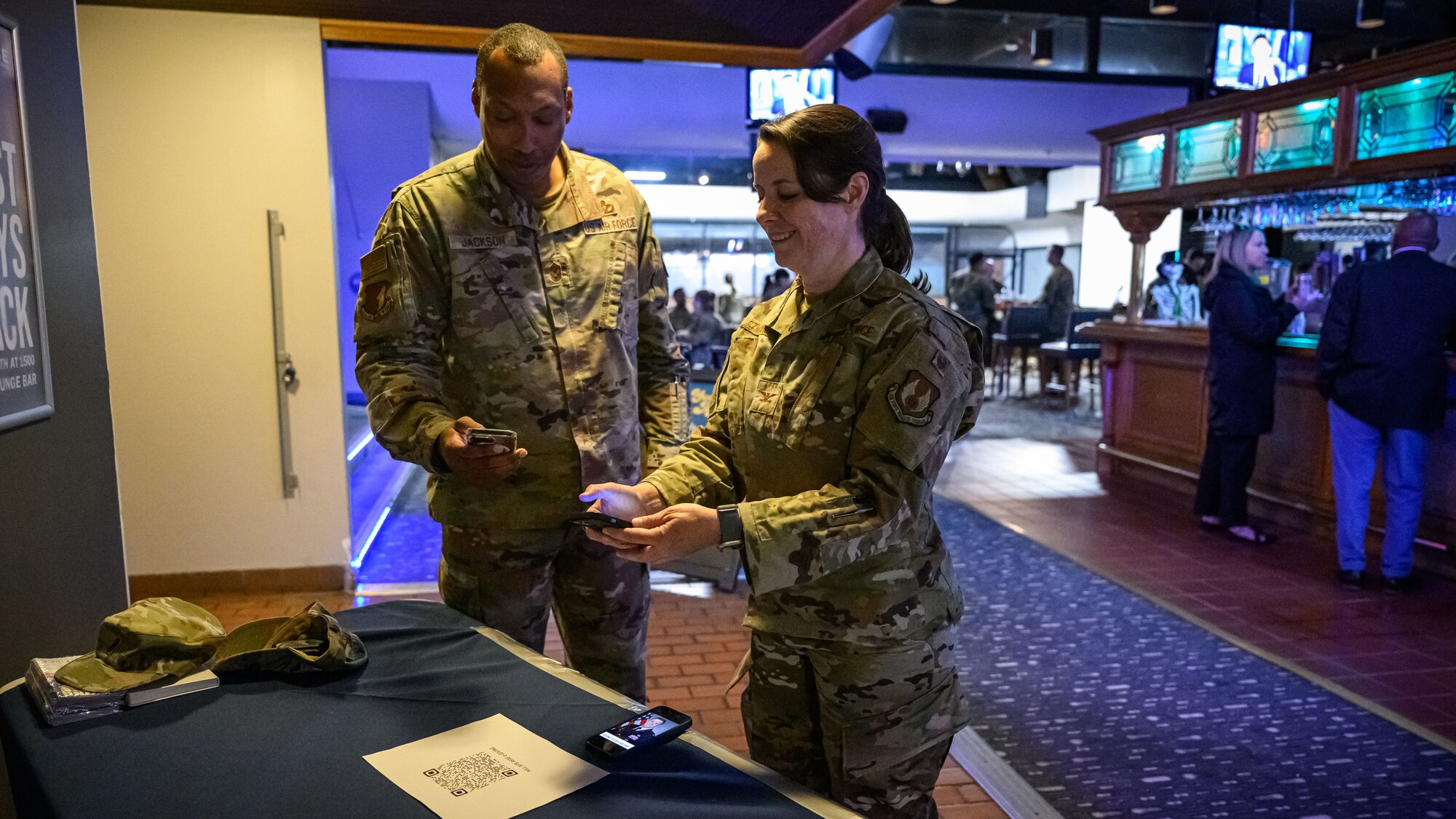 Chief Master Sgt. Jackson and Col. Szwarc can a QR code at the AFAF booth.