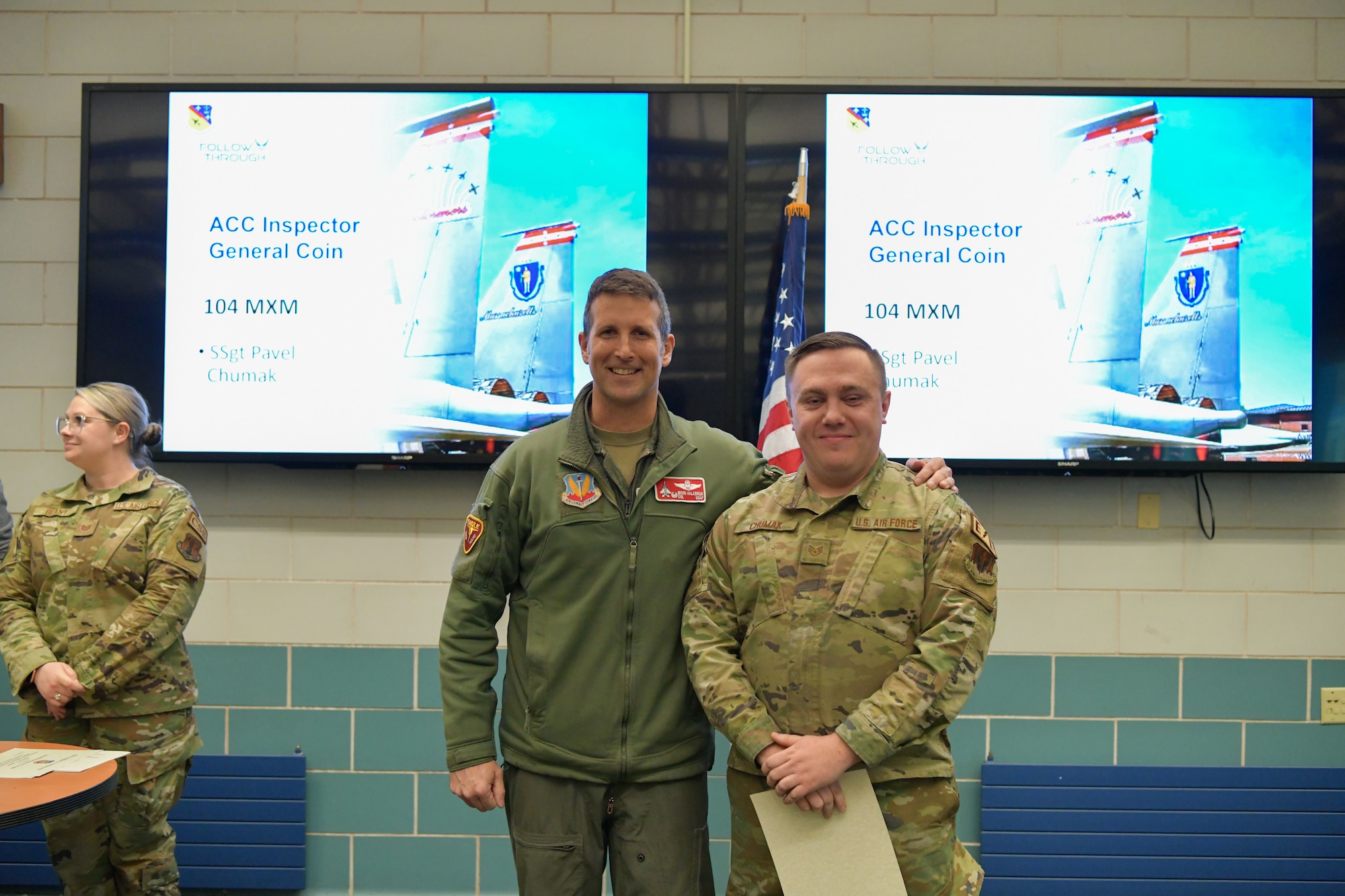 Colonel David Halasi-Kun, 104th Fighter Wing commander, presents a superior performer award and Air Combat Command Inspector General coin to Staff Sgt. Pavel Chumak, 104th Maintenance Group aircraft electrical and environmental systems technician, Thursday, March 21, 2024, at Barnes Air National Guard Base, Massachusetts. The 104th FW received 29 individual and 9 team recognitions and awards from the 2024 Unit Effectiveness Inspection for superior performance.