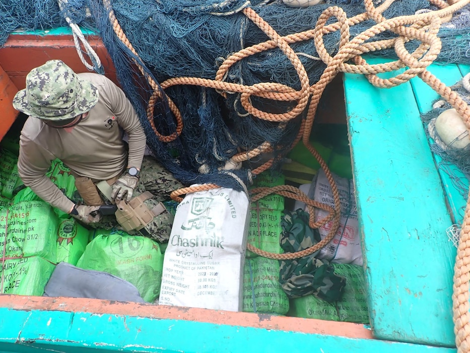 A Sailor removes illegal narcotics from the hull of a vessel seized by USCGC Glen Harris (WPC 1144) in the Arabian Sea.
