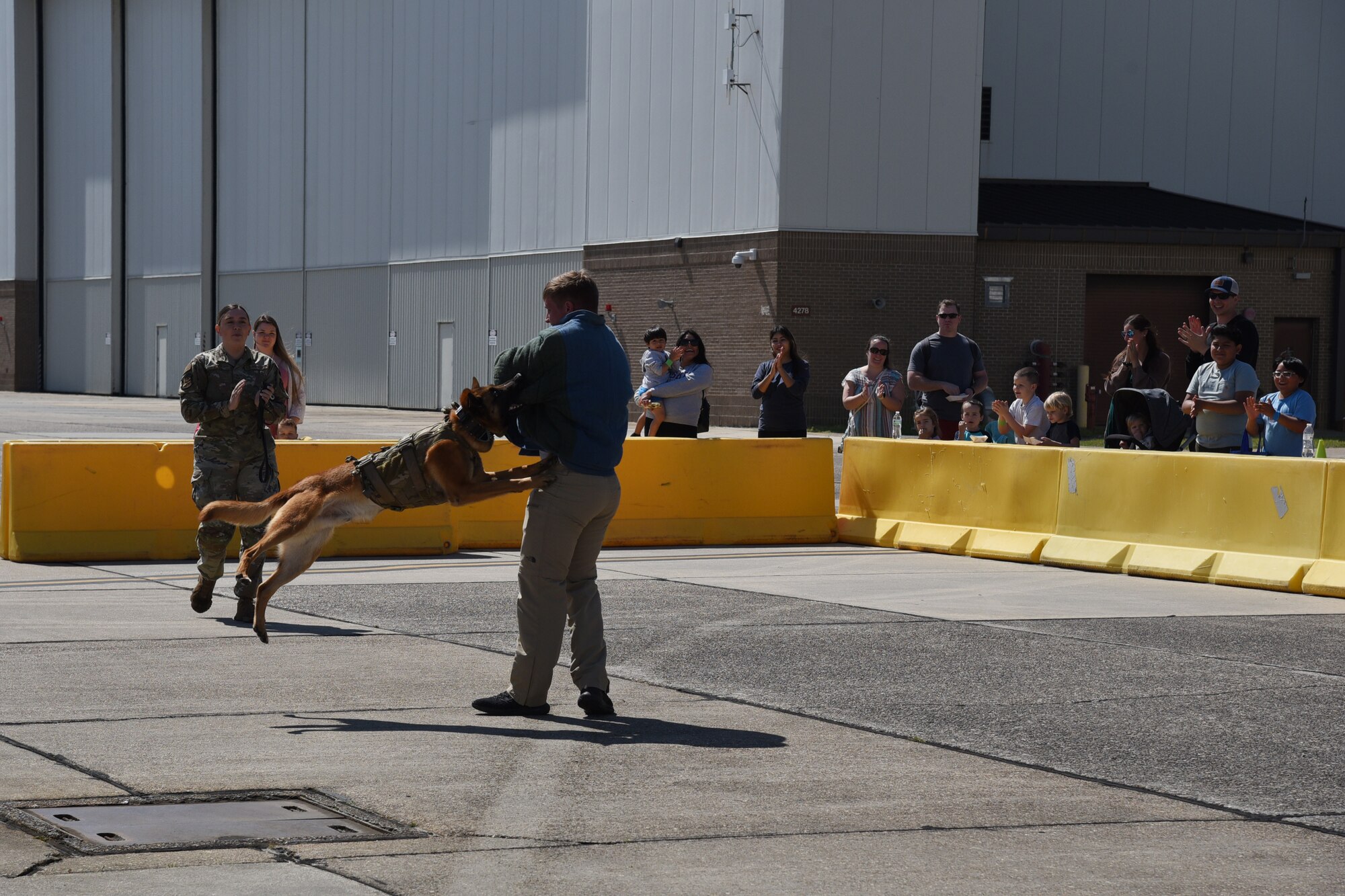 Military families watch the military police dog in action.