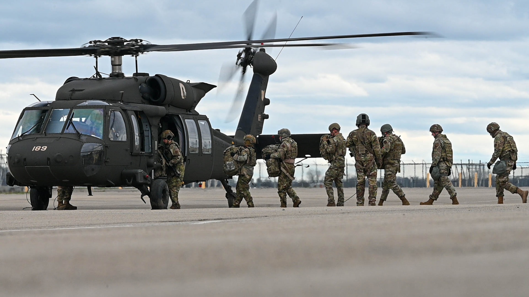 U.S. Air Force Airmen from the 178th Mission Support Group and 123d Air Control Squadron board a UH-60 Black Hawk from 1st Battalion, 137th Aviation Regiment, during Operation Guide Wire on Springfield-Beckley Air National Guard Base, Ohio, April 4, 2024. The UH-60 transported Airmen to a landing zone at Wright-Patterson Air Force Base, where a tactical operations center was set up.