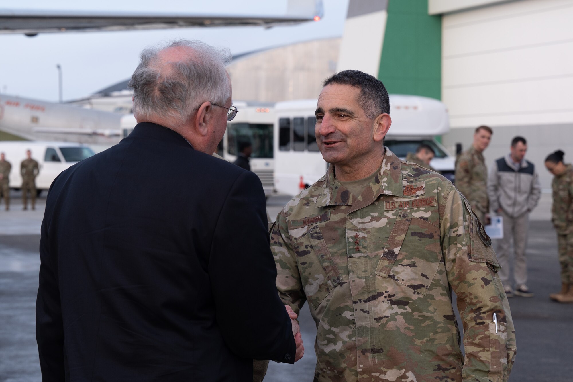 U.S. Air Force Lt. Gen. David Nahom, commander, Alaskan North American Aerospace Defense Command Region, Alaskan Command and Eleventh Air Force, shakes hands with Secretary of the Air Force Frank Kendall after he arrives at the Fairbanks International Airport