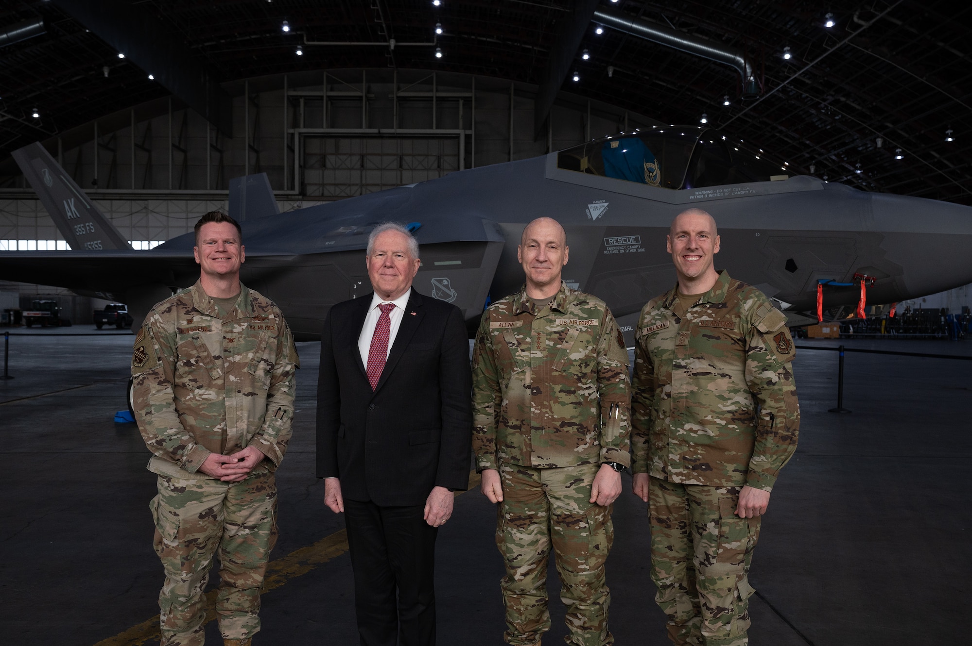 Secretary of the Air Force Frank Kendall and U.S. Air Force Chief of Staff Gen. David Allvin pose with Col. Paul Townsend, 354th Fighter Wing commander, and Chief Master Sgt. Sean Milligan, 354th FW command chief in front of an F-35A Lightning II aircraft.