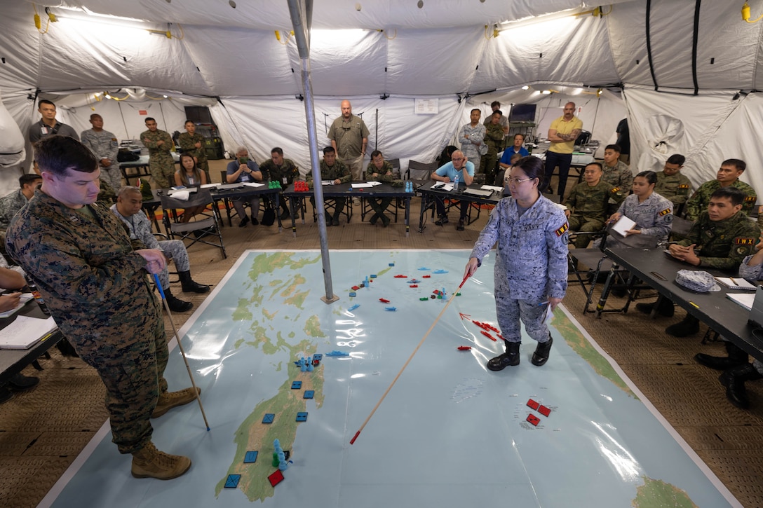 Philippine Navy Lt. Cmdr. Maria Christina Roxas, Chief of External Affairs Branch, Public Affairs Division, briefs her team’s plan to participants during the Information Warfighter Exercise, held before the commencement of Exercise Balikatan 24, at Camp Aguinaldo, Philippines, April 4, 2024. IWX is a week-long matrix-style wargame that advances the combined information-related capabilities of the U.S. and Armed Forces of the Philippines. BK 24 is an annual exercise between the Armed Forces of the Philippines and the U.S. military designed to strengthen bilateral interoperability, capabilities, trust, and cooperation built over decades of shared experiences. (U.S. Marine Corps photo by Cpl. Brian Knowles)