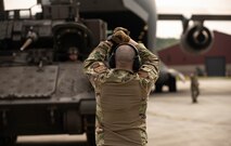 Soldiers with the 5th Squadron, 7th Cavalry Regiment, 1st Armored Brigade Combat Team (5-7 CAV), 3rd Infantry Division (3ID) and Airmen load an armored vehicle into C-17 and C-5 aircraft at Hunter Army Airfield, Savannah, Georgia, Apr. 2, 2024.