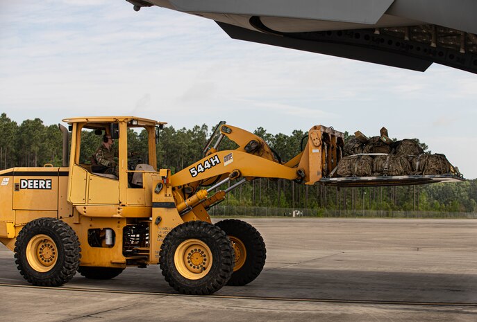 Soldiers, assigned to the 5th Squadron, 7th Cavalry Regiment, 1st Armored Brigade Combat Team (5-7 CAV), 3rd Infantry Division (3ID), load combat gear with Airmen into C-17 and C-5 aircraft at Hunter Army Airfield, Savannah, Georgia, Apr. 2, 2024.