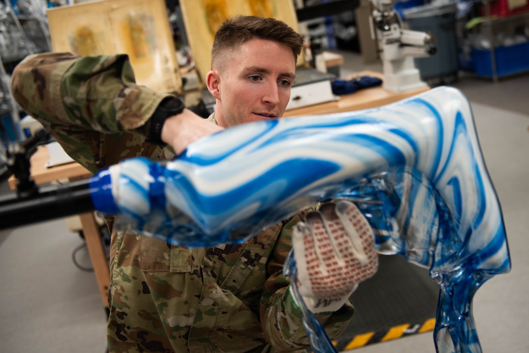 An Airman removes excess materials.