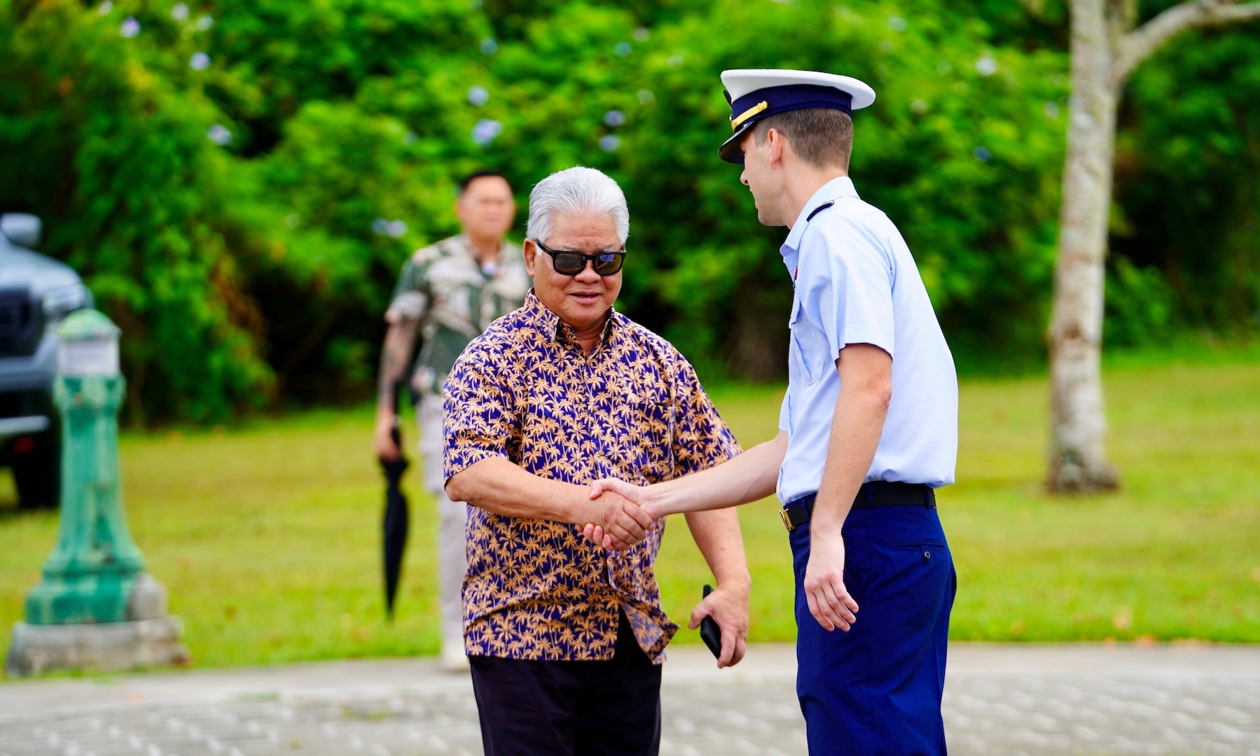Lt. Justin Miller, commanding officer of Marine Safety Unit Saipan, greets Gov. Arnold Palacios at a ceremony to formally establish MSU Saipan in Garapan at the American Memorial Park on April 5, 2024. This significant achievement marks a milestone in leadership evolution and responsibility expansion within the U.S. Coast Guard, reflecting steadfast commitment to serving the people of Saipan and the Commonwealth of the Northern Marianas Islands (CNMI) with unparalleled dedication and excellence. The change is part of an initiative to provide junior officers with increased command opportunities, fostering professional growth and leadership development within the ranks. Eighteen marine safety detachments are converting to marine safety units. (U.S. Coast Guard photo by Chief Warrant Officer Sara Muir)