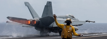 240408-N-YG401-1021 PHILIPPINE SEA (April 8, 2024) U.S. Navy Aviation Boatswain’s Mate 1st Class Michael Joseph, from Carrollton, Ga., signals aircraft as an F/A-18E Super Hornet, assigned to the “Flying Checkmates” of Strike Fighter Squadron (VFA) 211, takes off from the flight deck aboard the Nimitz-class aircraft carrier USS Theodore Roosevelt (CVN 71), April 8, 2024. Theodore Roosevelt, flagship of Carrier Strike Group Nine, is underway conducting routine operations in the U.S. 7th Fleet area of operations. U.S. 7th Fleet is the U.S. Navy’s largest forward-deployed numbered fleet, and routinely interacts and operates with allies and partners in preserving a free and open Indo-Pacific region. (U.S. Navy photo by Mass Communication Specialist 2nd Class Andrew Benvie)