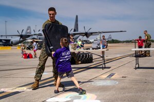 A student in the Keesler Marine Detachment spars with a military child at Operation HERO at Keesler Air Force Base, Mississippi, April 6, 2024.