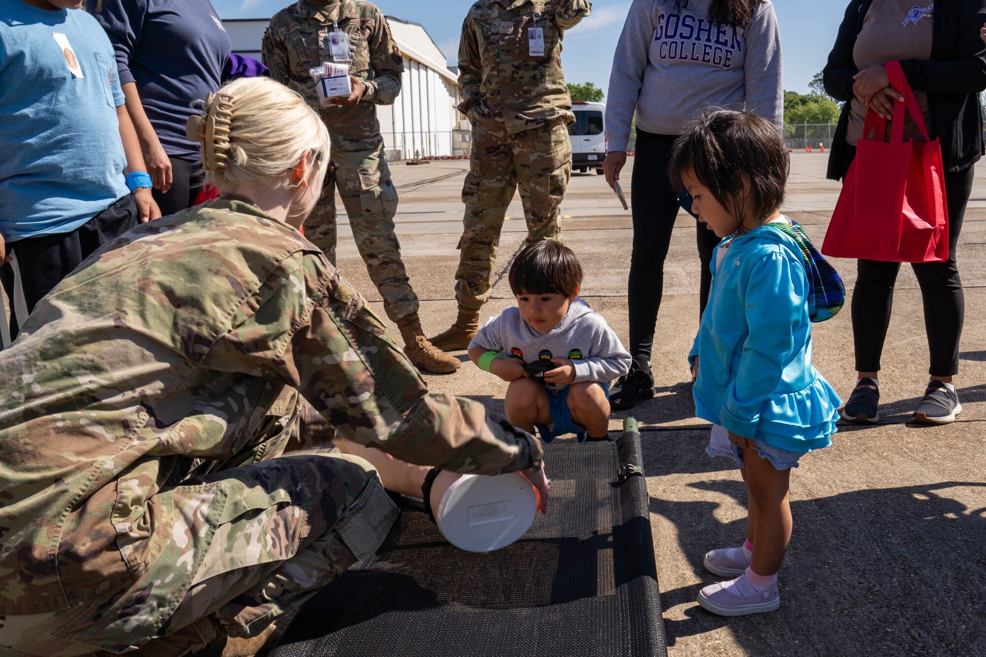 U.S. Air Force Staff Sgt. Rebecca Polhemus, 81st Medical Group medical technician, shows a military child how to apply a tourniquet during Operation HERO at Keesler Air Force Base, Mississippi, April 6, 2024.