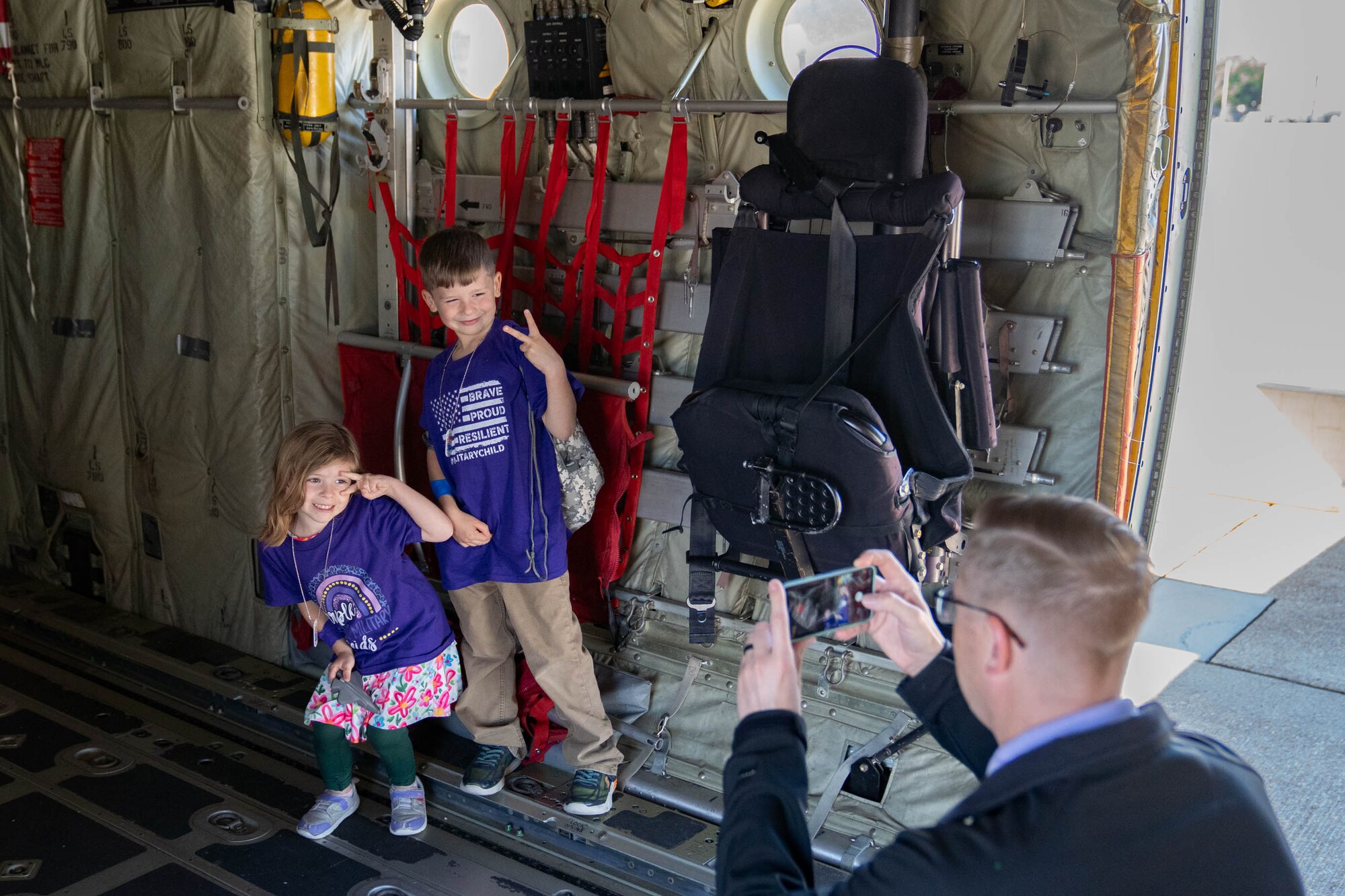U.S. Air Force Lt. Col. Nicholas Kuc, 333rd Training Squadron commander, takes a photo of his children aboard a C-130J during Operation HERO at Keesler Air Force Base, Mississippi, April 6, 2024.