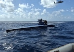 The Ticonderoga-class guided missile cruiser USS Leyte Gulf (CG 55), embarked U.S. Coast Guard Law Enforcement Detachment (LEDET) and Helicopter Maritime Strike Squadron (HSM) 50 work together to intercept a self-propelled semi-submersible drug smuggling vessel (SPSS), in the Atlantic Ocean, March 22, 2024. Leyte Gulf is on a scheduled deployment in the U.S. Naval Forces Southern Command area of operations, employed by U.S. Fourth Fleet to support joint and combined military operations, which includes counter-illicit drug trafficking missions in the Caribbean and the Atlantic.