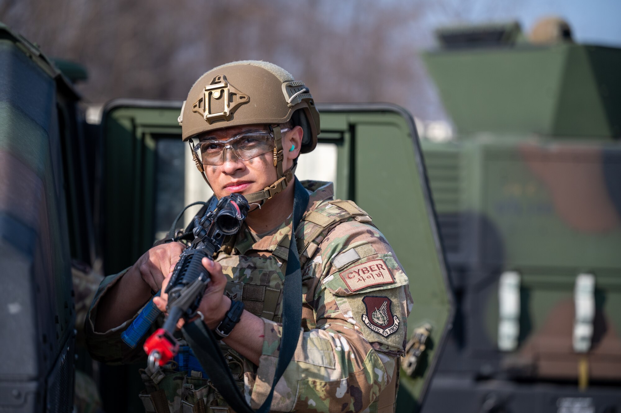 U.S. Air Force Airman 1st Class Christian Fernandez, 51st Communications Squadron cyber systems technician, scans the area for simulated opposing forces during a Combat Readiness Course at Osan Air Base, Republic of Korea, March 14, 2024. The CRC builds a comprehensive defense framework and develops Mission Ready Airmen prepared to tackle any challenge and deter any adversary in the defense of Osan AB and the ROK. (U.S. Air Force photo by Staff Sgt. Thomas Sjoberg)