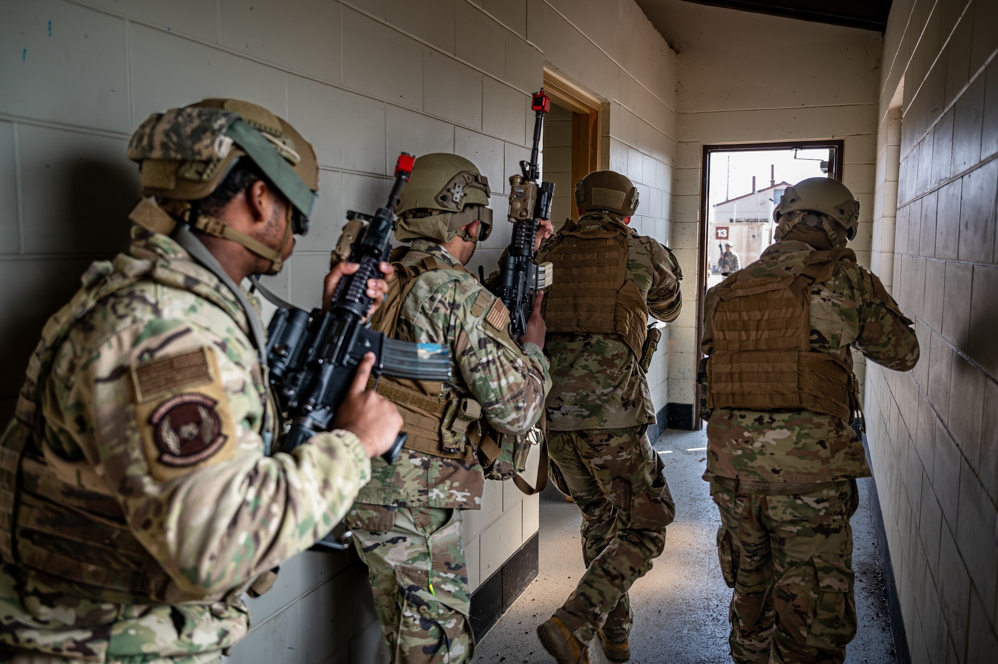 U.S. Airmen assigned to the 51st Fighter Wing practice room clearing techniques during a combat readiness course at Osan Air Base, Republic of Korea, March 14, 2024. The CRC builds a comprehensive defense framework at Osan AB and develops Mission Ready Airmen prepared to tackle any challenge and deter any adversary. (U.S. Air Force photo by Staff Sgt. Thomas Sjoberg)