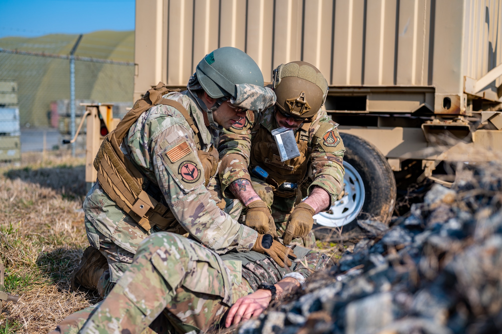 U.S. Air Force Staff Sgt. Christopher Williams, left, 51st Logistics Readiness Squadron traffic management operations technician, and Senior Airman Ethan McGregor, 51st LRS aircraft parts store journeyman, provide simulated tactical combat casualty care during a Combat Readiness Course at Osan Air Base, Republic of Korea, March 14, 2024. During the training, CRC students are trained in TCCC, enhancing their life-saving skills for potential real-world contingencies. (U.S. Air Force photo by Staff Sgt. Thomas Sjoberg)