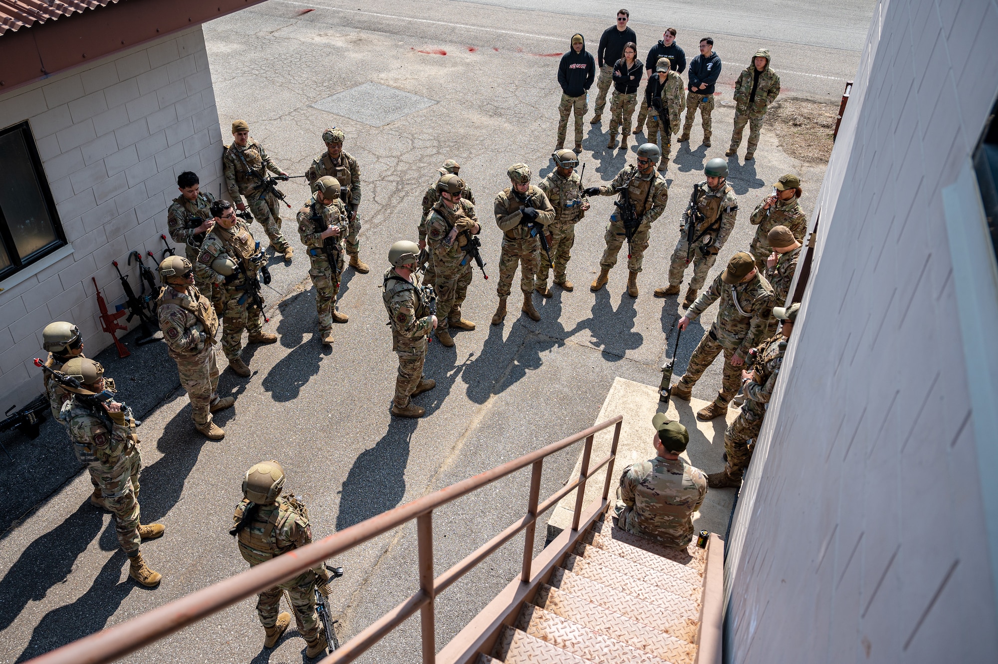 U.S. Airmen assigned to the 51st Fighter Wing receive feedback after completing a simulated combat scenario during a Combat Readiness Course at Osan Air Base, Republic of Korea, March 14, 2024. The CRC trains 51st FW Airmen on base defense procedures, preparing them to tackle any challenge and deter any adversary during contingency operations. (U.S. Air Force photo by Staff Sgt. Thomas Sjoberg)