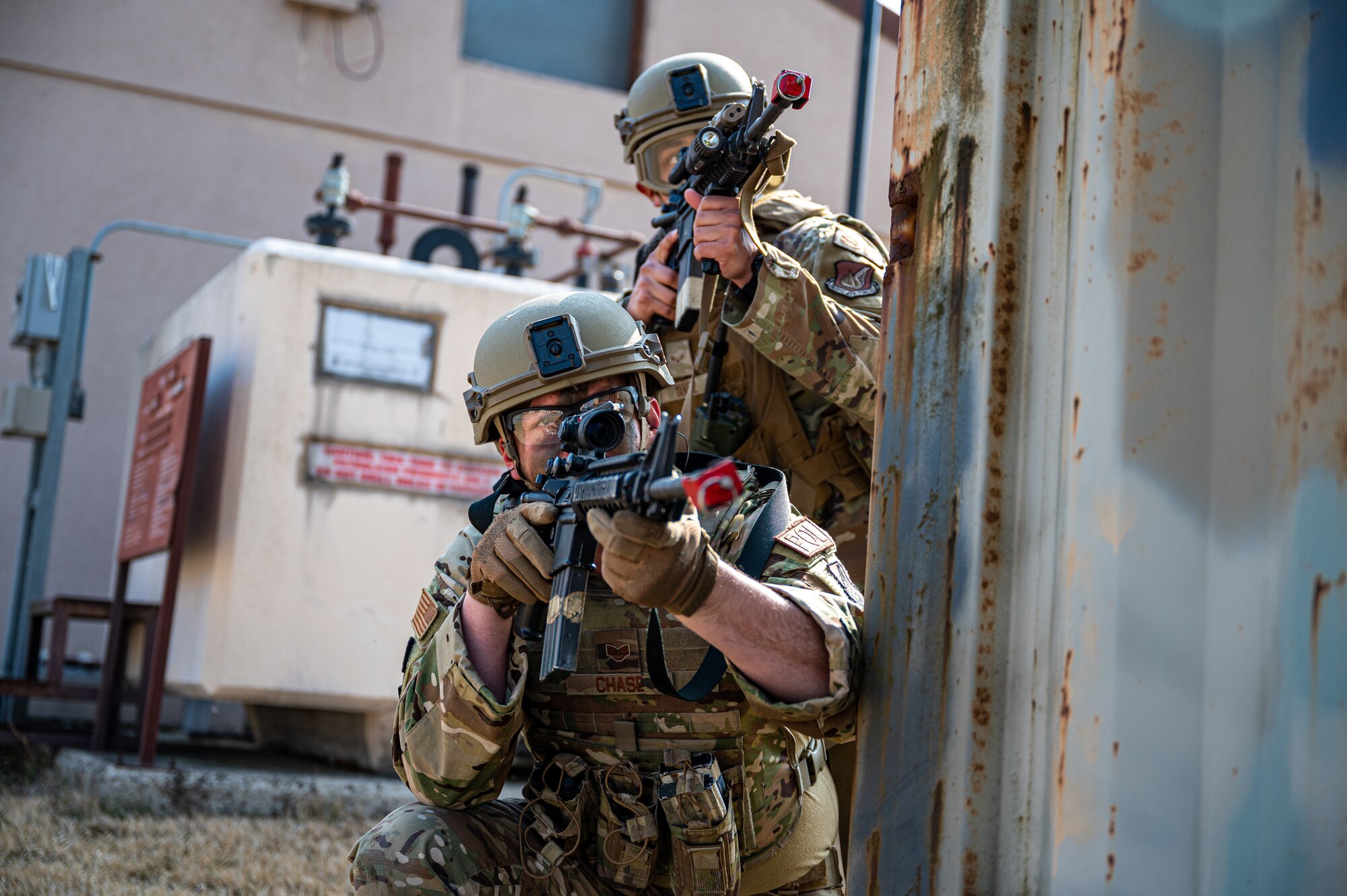 U.S. Air Force Staff Sgt. Chandler Chase, left, 51st Logistics Readiness Squadron fuels supervisor, and Airman 1st Class Alan Yanez, 51st Security Forces Squadron Defender, scan the area for simulated opposing forces during a Combat Readiness Course at Osan Air Base, Republic of Korea, March 14, 2024. The CRC equips Airmen with advanced combat tactics and life saving skills, enabling them to confront any challenge and deter adversaries in defense of Osan AB and the ROK. (U.S. Air Force photo by Staff Sgt. Thomas Sjoberg)