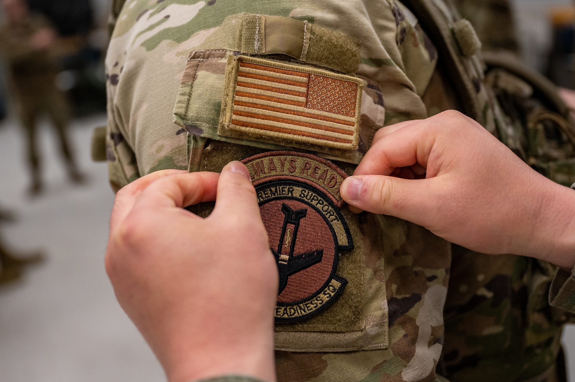 An “Always Ready” patch is placed on U.S. Air Force Staff Sgt. Chandler Chase, 51st Logistics Readiness Squadron fuels supervisor, after graduating the Combat Readiness Course at Osan Air Base, Republic of Korea, March 15, 2024. Throughout the 10-day course, Chase trained on diverse base defense tactics like weapon safety and manipulation, tactical casualty combat care, mounted and dismounted operations, close quarters combat and more. (U.S. Air Force photo by Staff Sgt. Thomas Sjoberg)