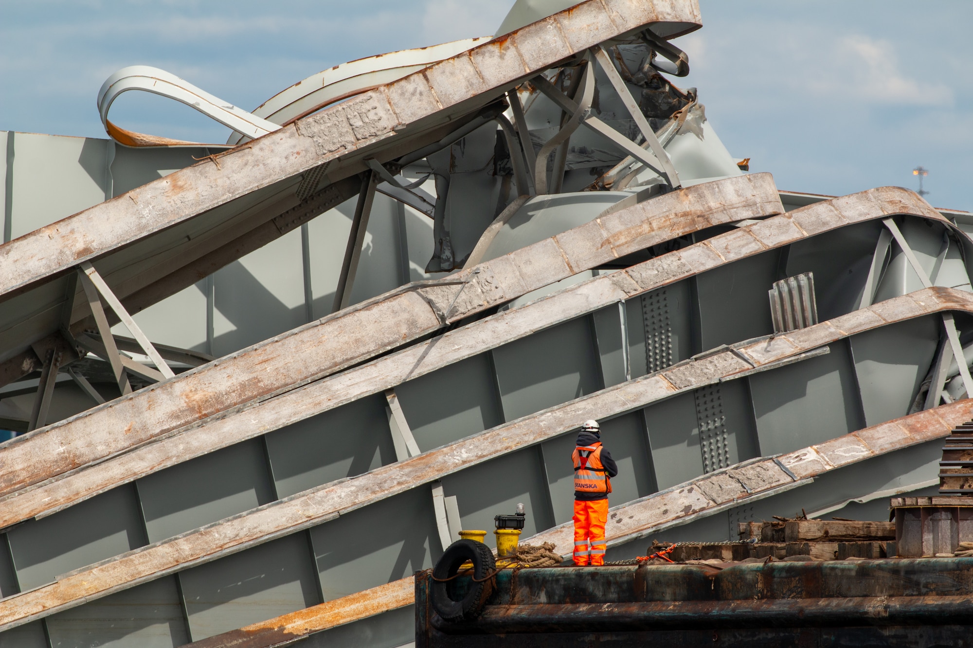 A man looks at wreckage debris.