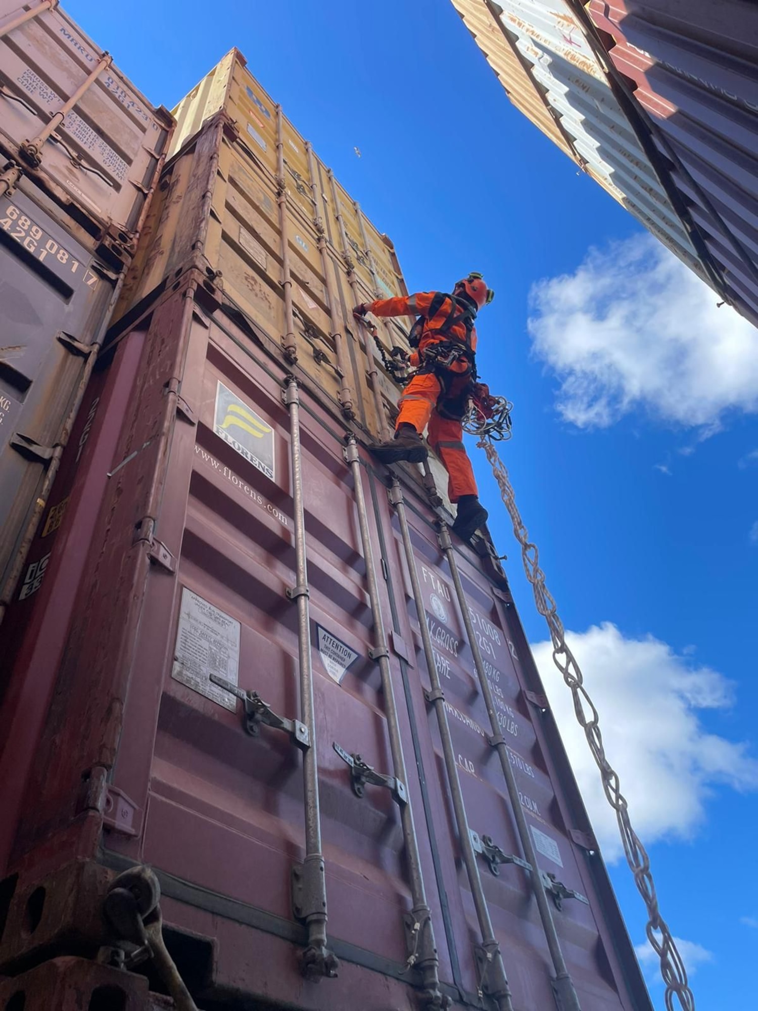 Man climbing a shipping container