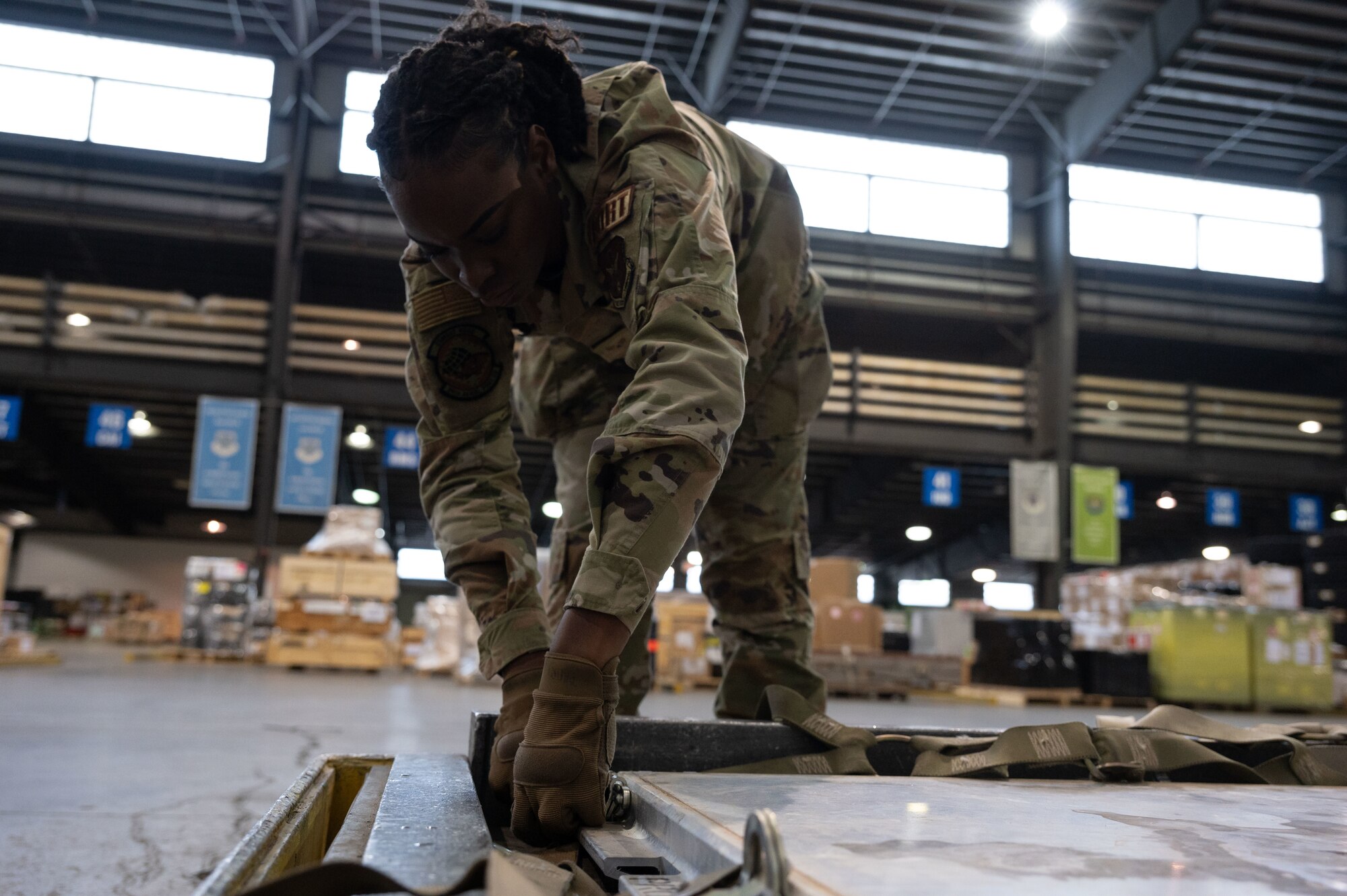 U.S. Air Force Senior Airman Priana Hart, 96th Aerial Port Squadron air transportation journeyman, secures a pallet strap at Dover Air Force Base, Delaware, April 4, 2024. The 436th APS, known as Dover AFB’s “Super Port,” has played a pivotal role in the base’s ongoing mission of rapid global mobility. (U.S. Air Force photo by Airman 1st Class Dieondiere Jefferies)