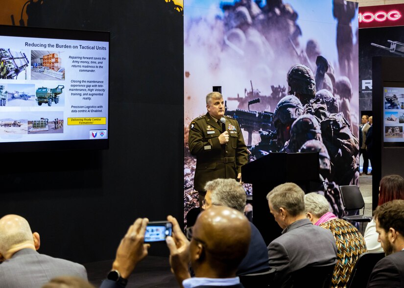 Soldier talks to crowd of people.