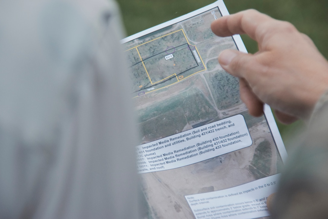 A hand pointing at a map.