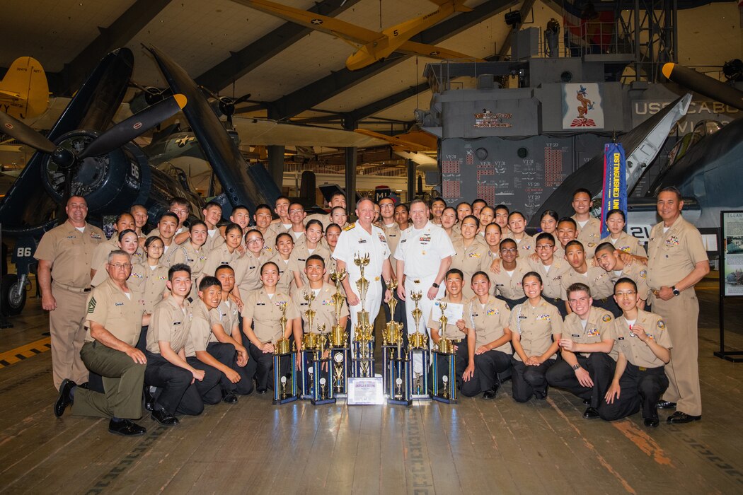 Commander, Naval Education and Training Command, Rear Adm. Jeffrey Czerewko, and Force Master Chief, NETC, Force Master Chief Rick Mengel, take a group photo with the 2024 Navy Junior Reserve Officers Training Corps (NJROTC) National Champions, Troy High School (Fullteron, Calif.), after the awards ceremony on Naval Air Station Pensacola, Fla. The NJROTC program is under the leadership of Commander, Naval Service Training Command (NSTC) Rear Adm. Craig Mattingly and his staff, headquartered at Naval Station Great Lakes, Il. NSTC supports 98 percent of officer and enlisted initial accessions training. NSTC’s support includes Recruit Training Command at Naval Station Great Lakes, Ill., the Naval ROTC program at more than 160 colleges and universities, Officer Training Command at Newport, R.I., and NJROTC Navy National Defense Cadet Corps citizenship development programs at nearly 600 high schools worldwide.