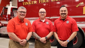 fire inspectors pose for photo in front of fire truck