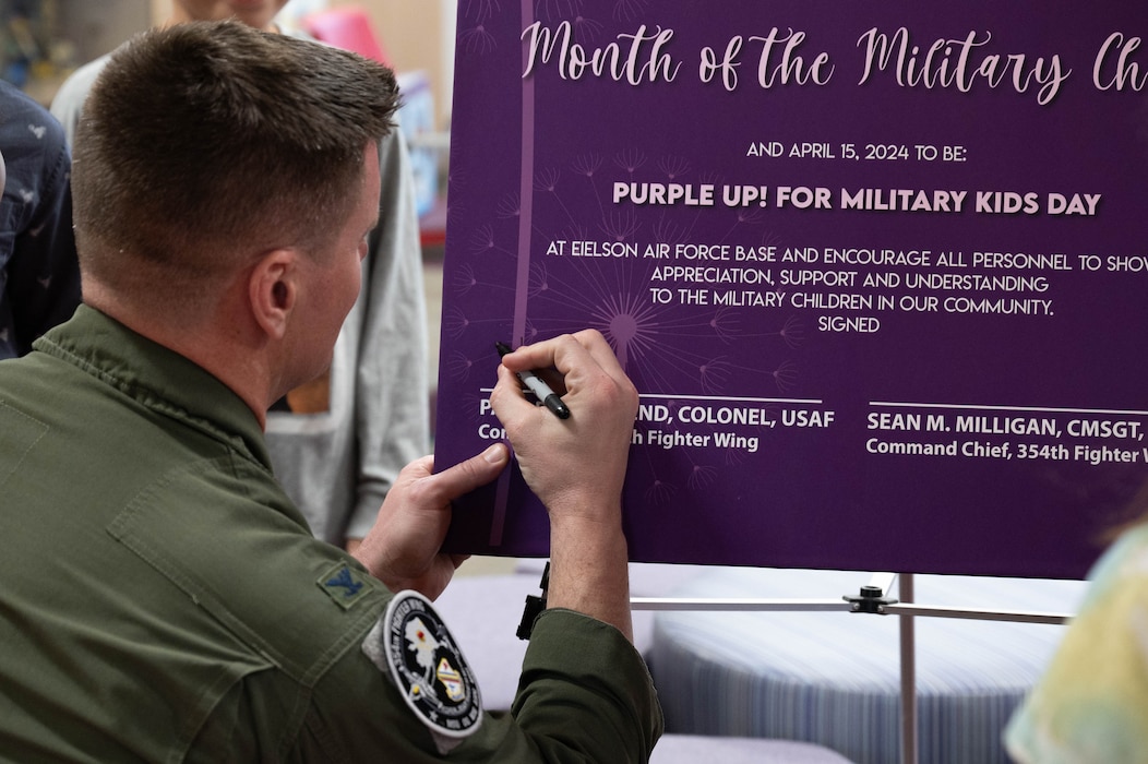 U.S. Air Force Col. Paul Townsend, 354th Fighter Wing commander, signs the proclamation of the Month of the Military Child at Eielson Air Force Base, Alaska, April 5, 2024.