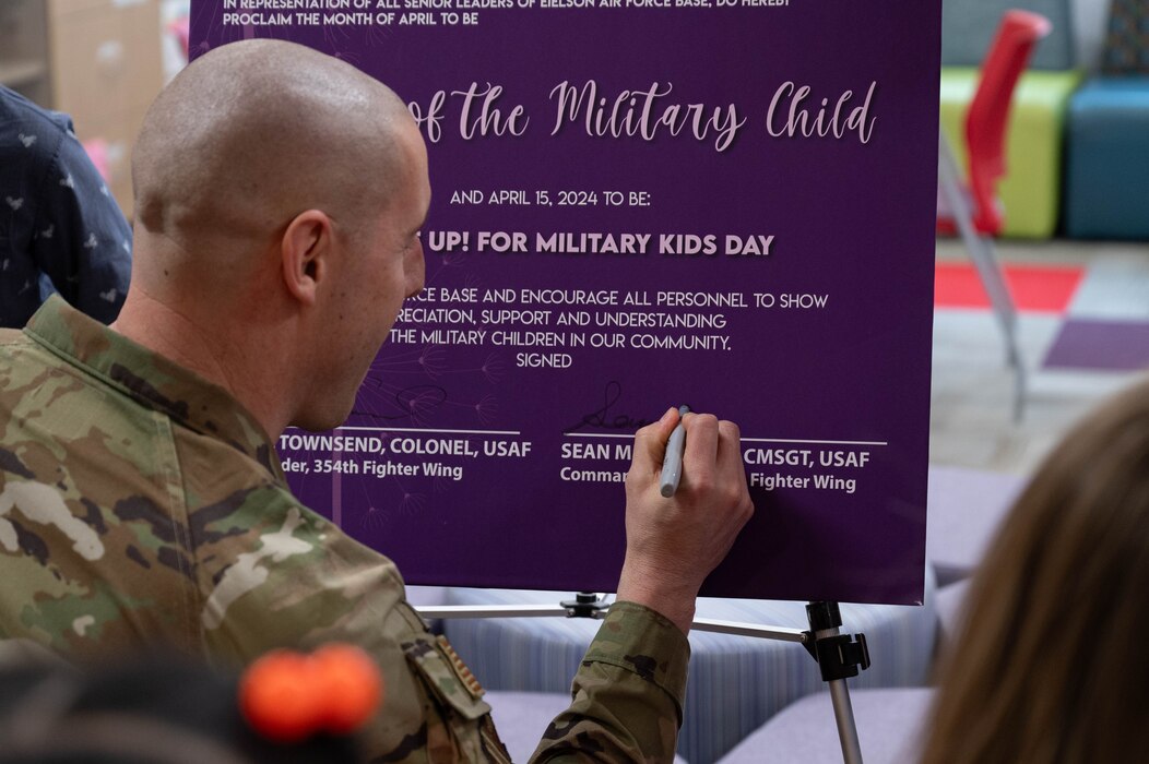 U.S. Air Force Chief Master Sgt. Sean Milligan, 354th Fighter Wing command chief, signs the proclamation of the Month of the Military Child at Eielson Air Force Base, Alaska, April 5, 2024.