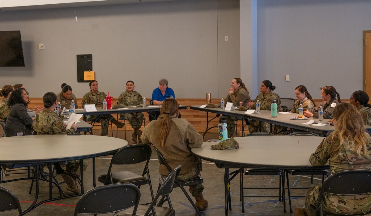 Women from the 354th Fighter Wing sit in a circle during the women's panel lunch and learn event.