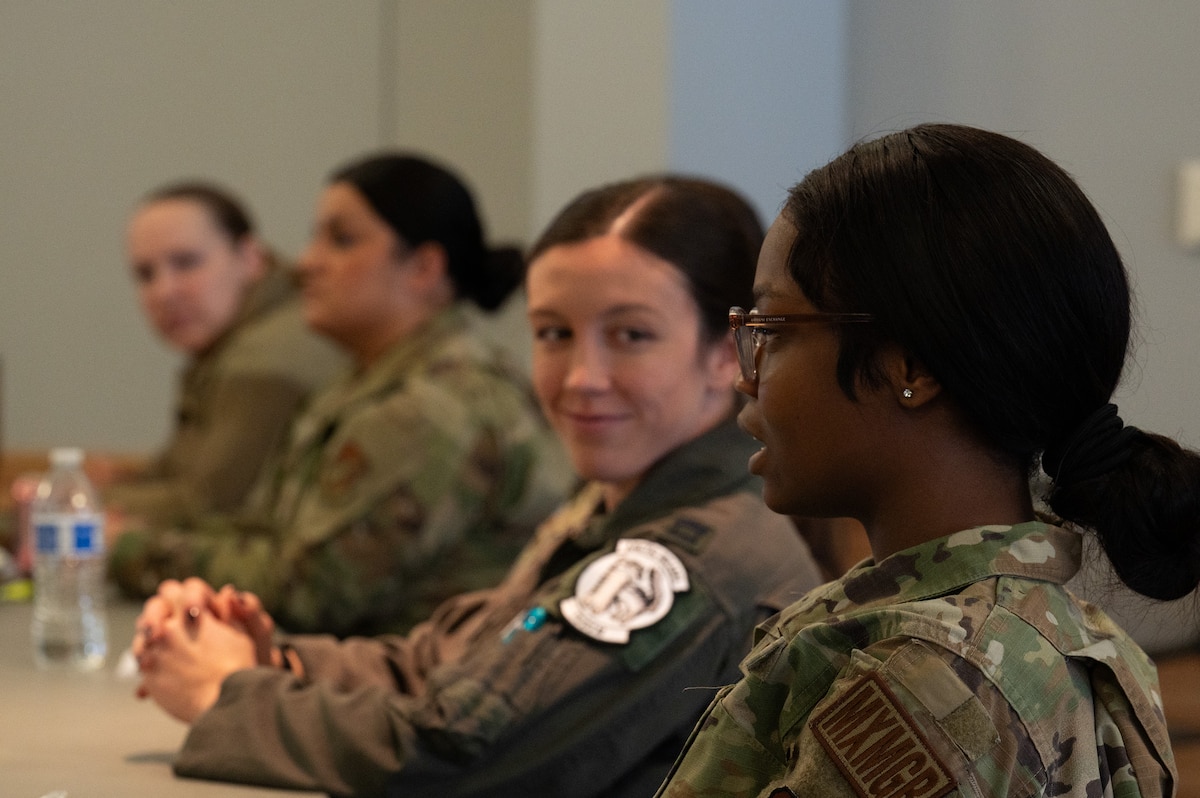Women from the 354th Fighter Wing sit at a table and talk about their experiences and insights as women serving in the military.