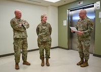 Lt. Col. Kevin Rasmussen, 59th Medical Specialty Squadron commander, expresses pride as Col. Wendi Wohltmann, 59th Medical Specialty Squadron dermatopathologist and dermatologist, is presented with the Military Health System 2023 Award for the Advancement of Women Physicians in Military Medicine at Wilford Hall Ambulatory Surgical Center, Joint Base San Antonio-Lackland, Texas, Feb. 7, 2024. The award not only recognizes individual efforts but also serves to inspire and encourage others to continue championing diversity and equality within the military healthcare system. (U.S. Air Force photo by Senior Airman Melody Bordeaux)